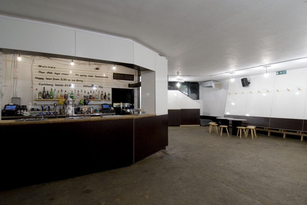 image of the early 2000's ArtBar, white ply walls, white bar, minimalist white furniture