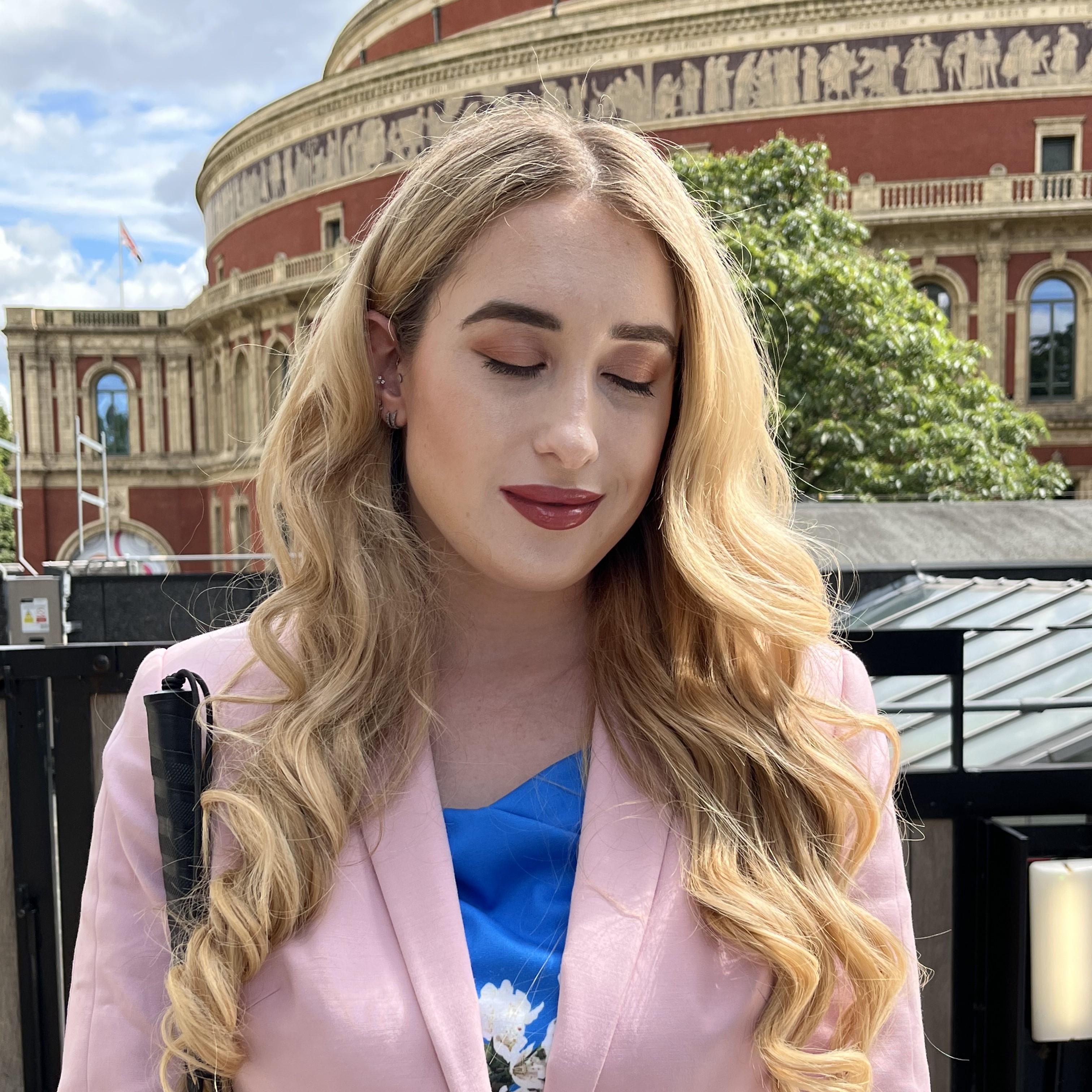 A photograph of Kimberley stood in front of the Royal Albert Hall